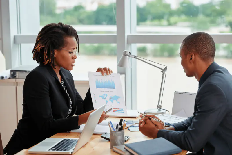 Deux consultants analysant un rapport en réunion